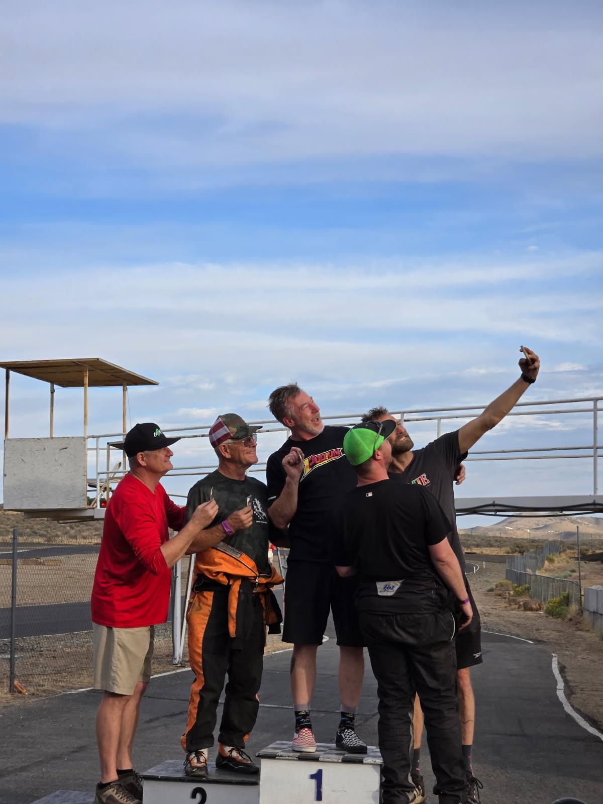 1Podium1 team celebrating with a selfie on a kart racing podium
